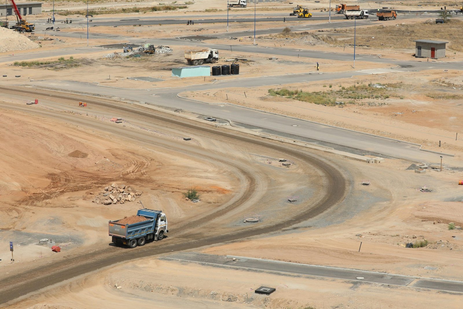 Aerial shot of a construction site in Konza, Kenya, showing dirt roads and machinery.